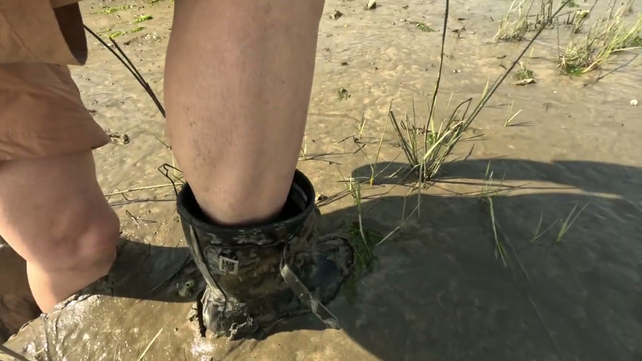 Flooded hunters in thick tidal mud.