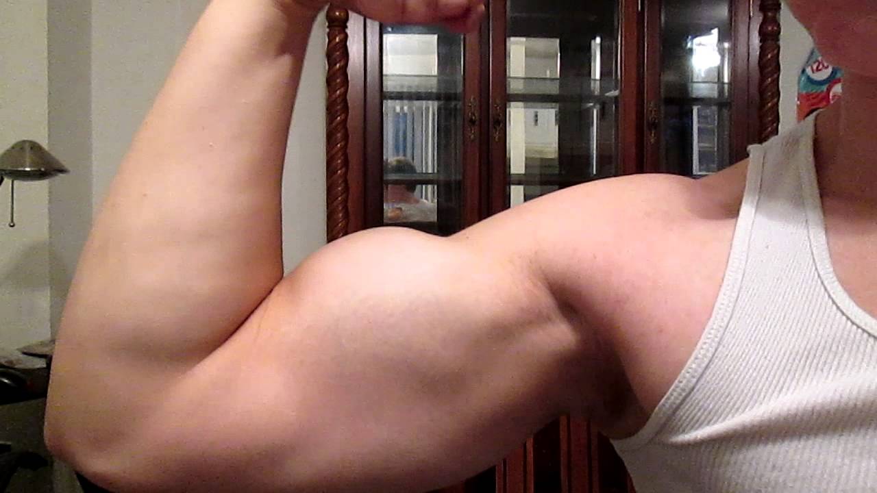 16 year old bodybuilder flexing and measuring arm