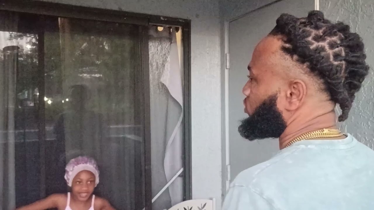 Heart locs style with a dagger in the middle for Valentine's Day.