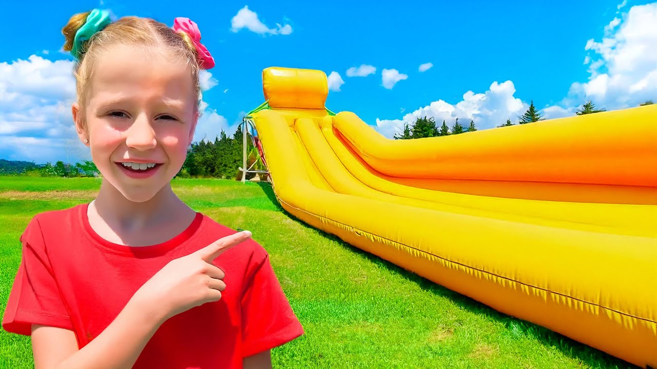 Nastya and Evelyn play outside with a huge trampoline