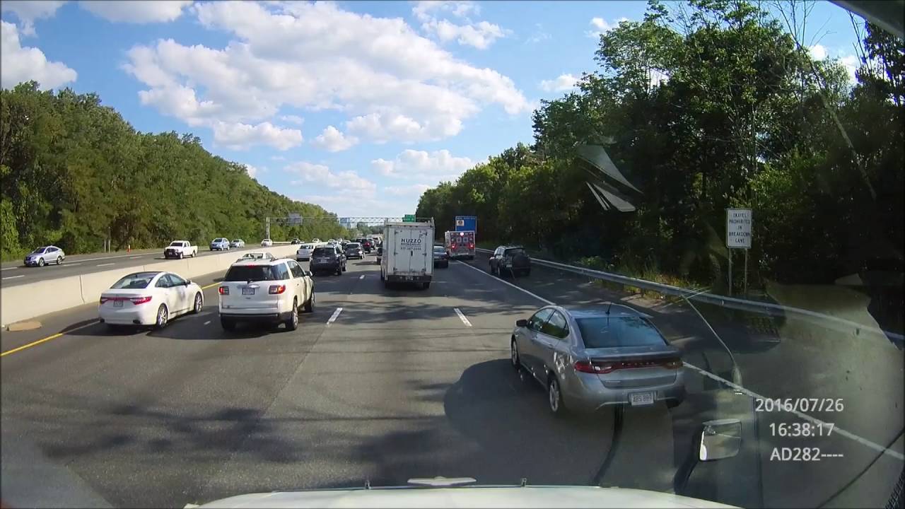 Small SUV follows ambulance on shoulder to get around traffic