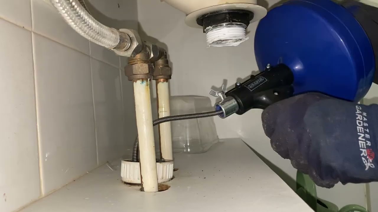 Unblocking my bathroom sink with a drain auger (drain snake)