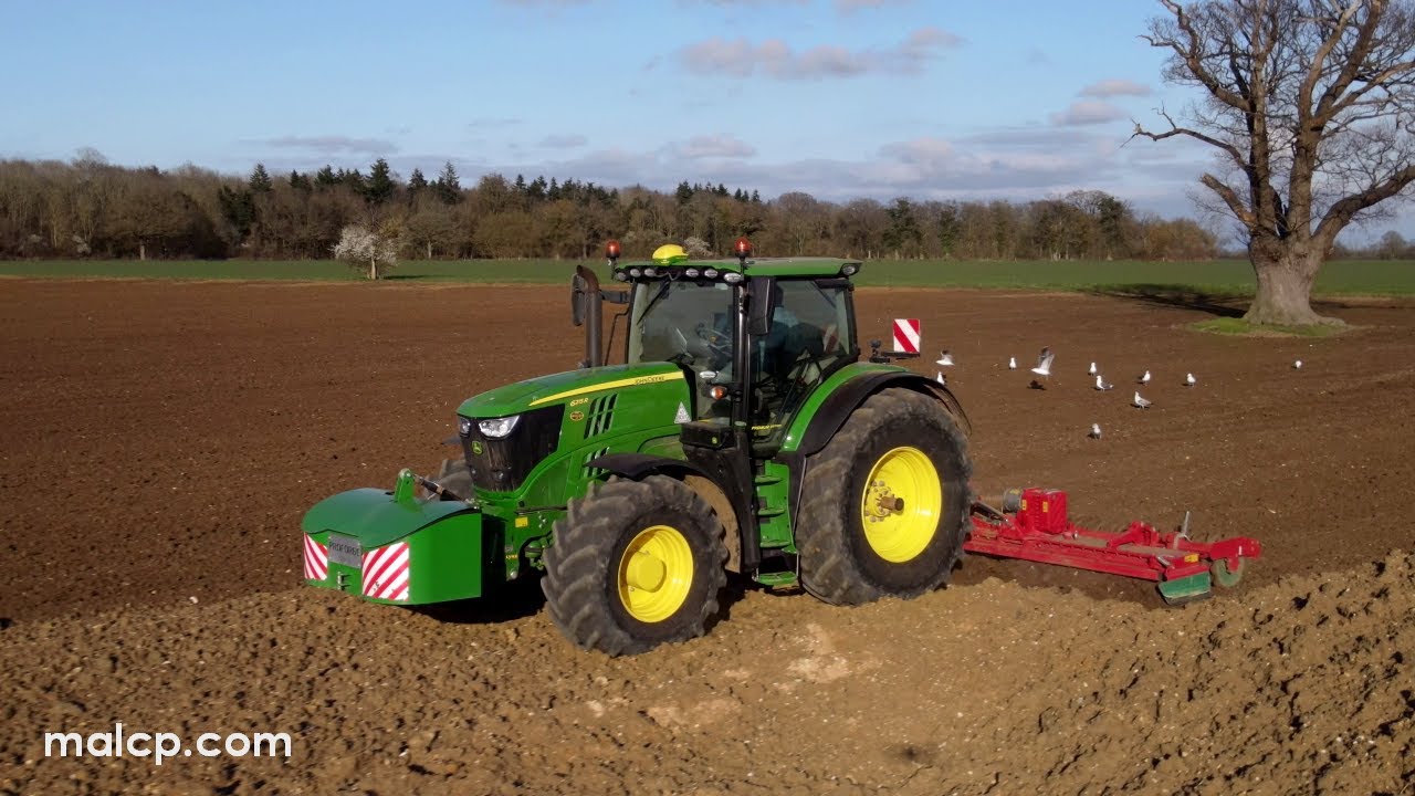 4k John Deere 6215R Premium & Kverneland 6m Foldable Power Harrow in the evening sunlight in Suffolk