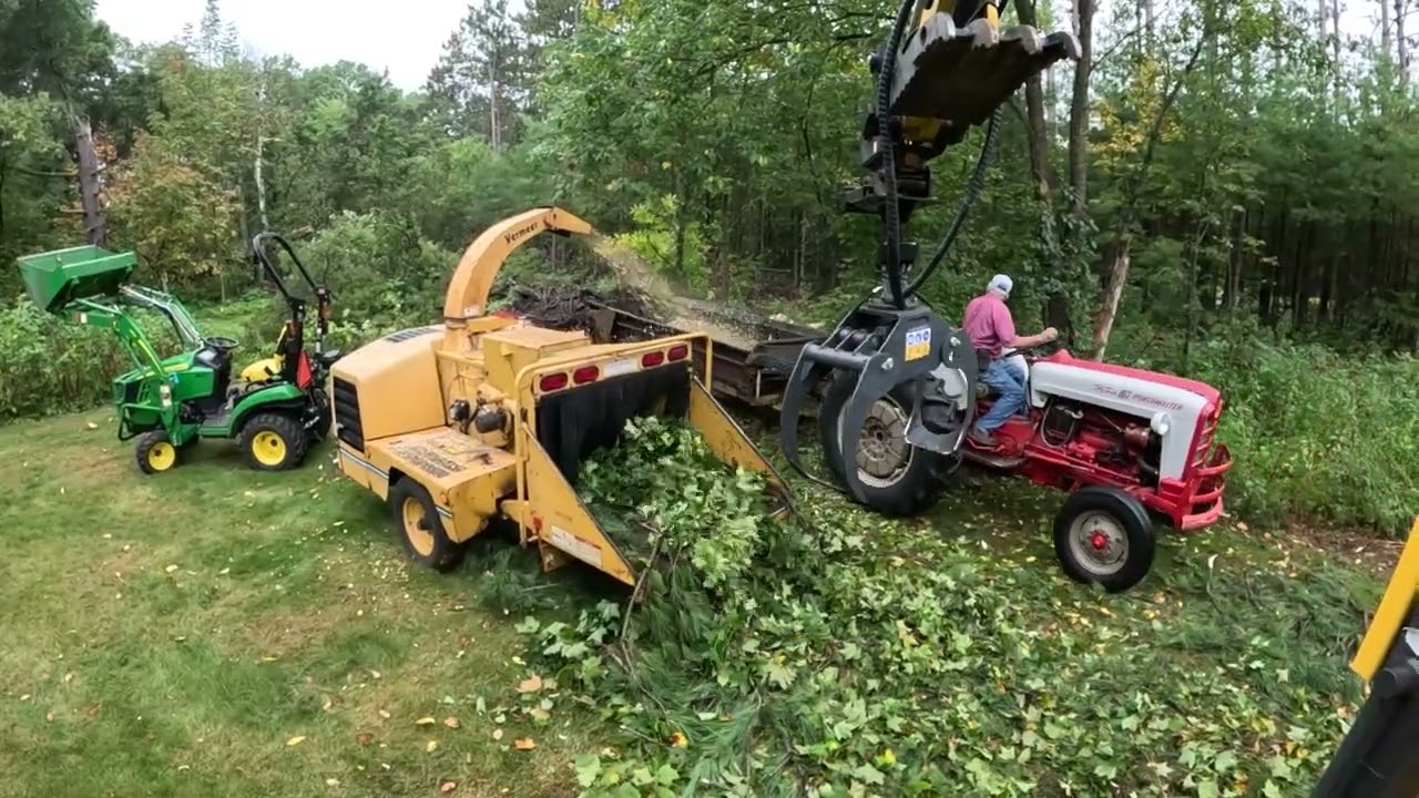 Excavator feeding wood chipper