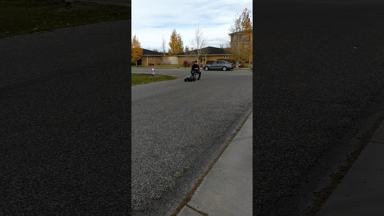 Traxxas XMAXX pulls man down street on office chair