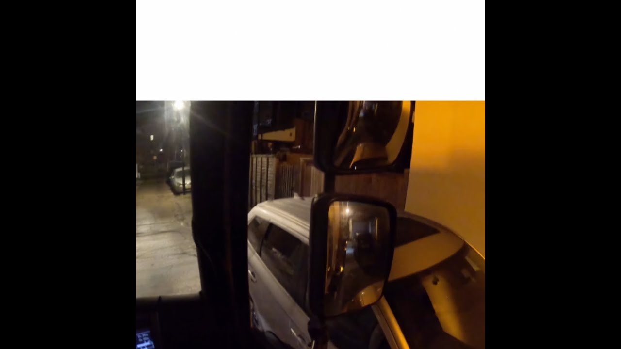 Dustcart driver reverses in a dark tight alleyway in London: POV Town centre bin tipping