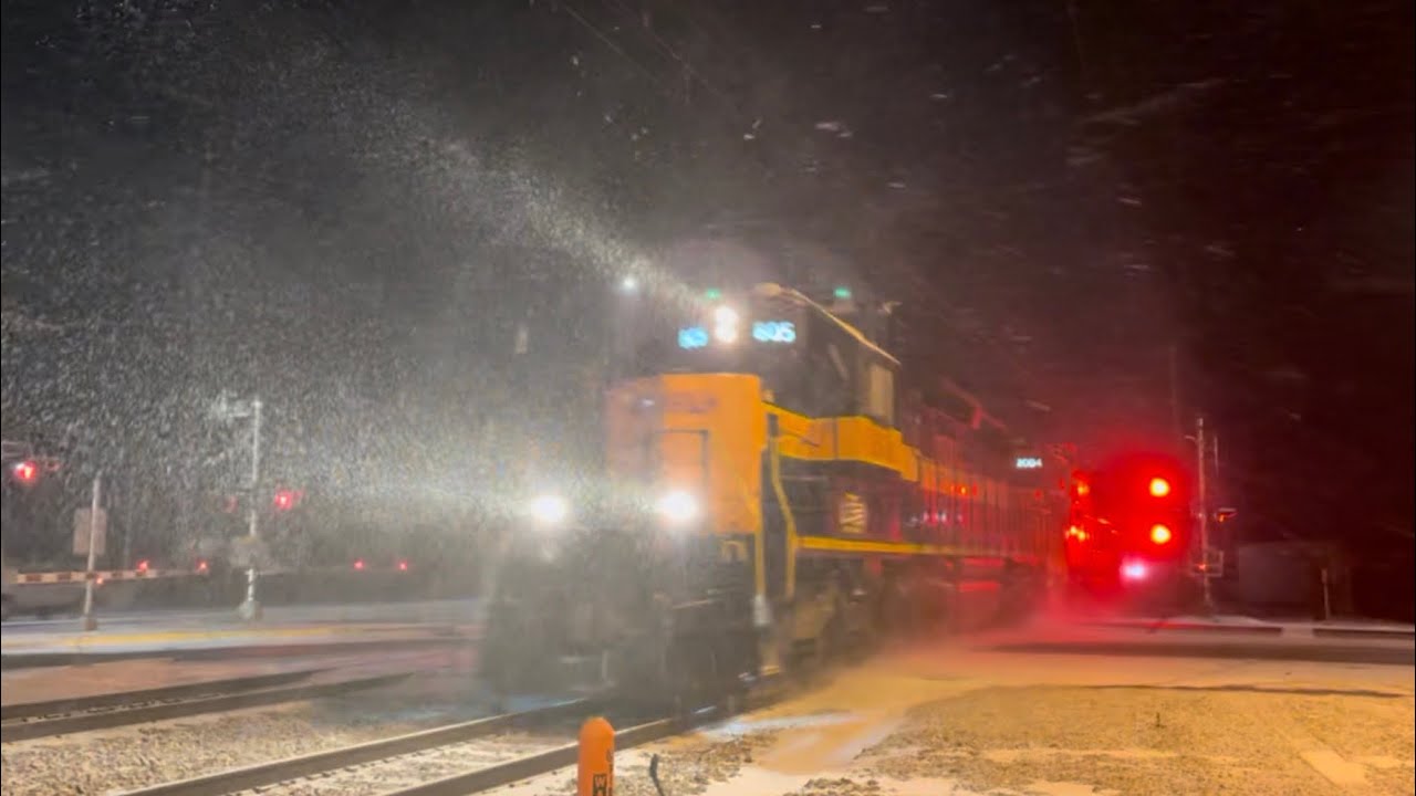 A eastbound NS autorack and CSS 805 +1 as light power race at Ogden dunes in heavy snowfall
