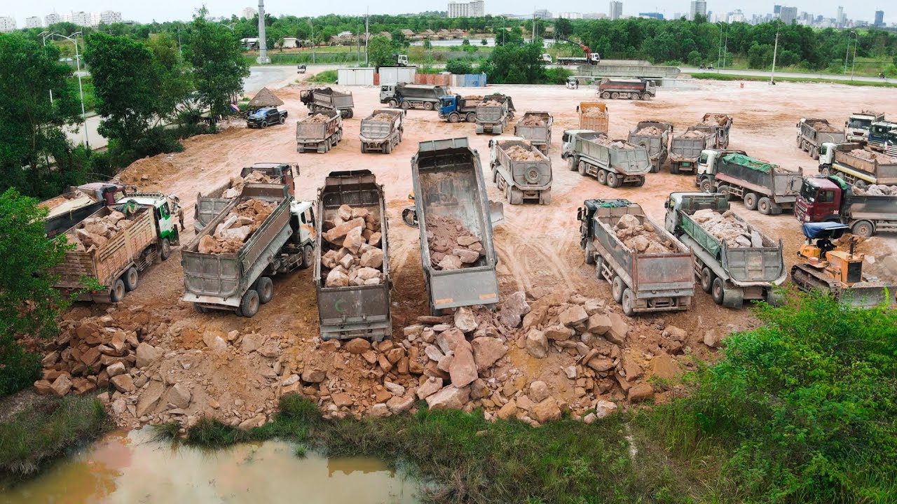 Big Project Filling Mountain Stones Operated By Team Bulldozer Heavy Machines And Trucks Dumping