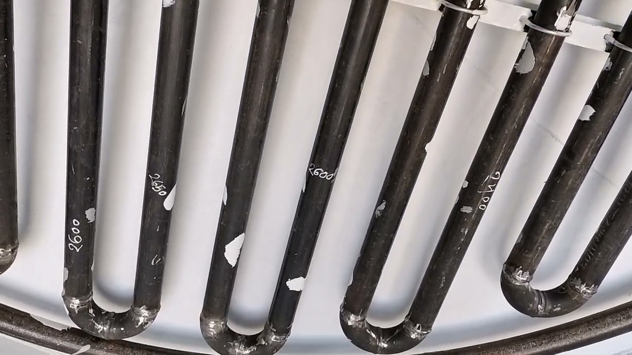 Vertical storage tank with heating coil fabrication.