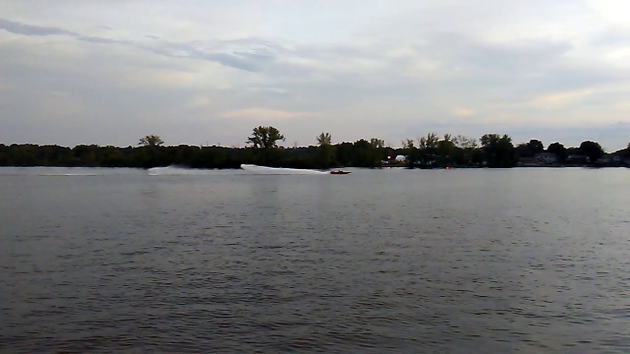 Loud v-drive boat passing by with rooster tail