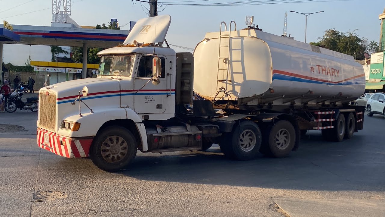 Large and small trucks on the road.