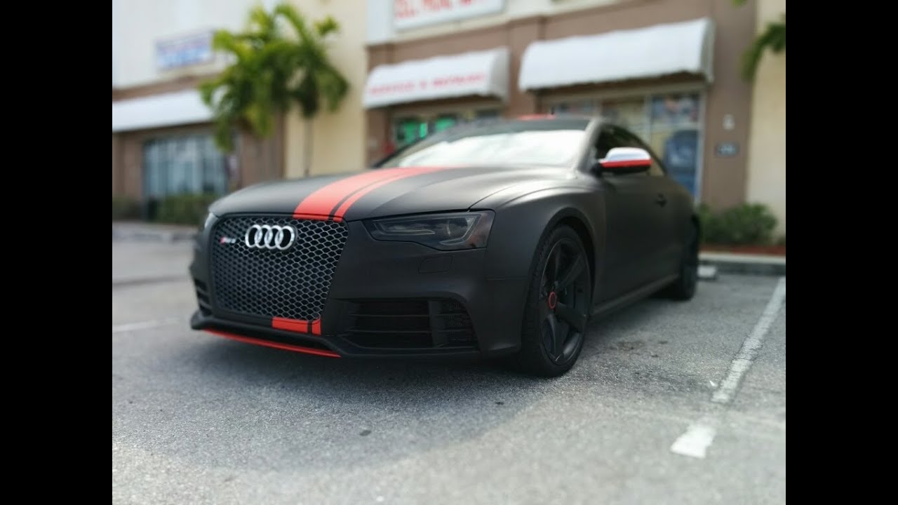 Audi RS 5 wrapped in 3M matte black with matte red stripes by Florida Car Wrap