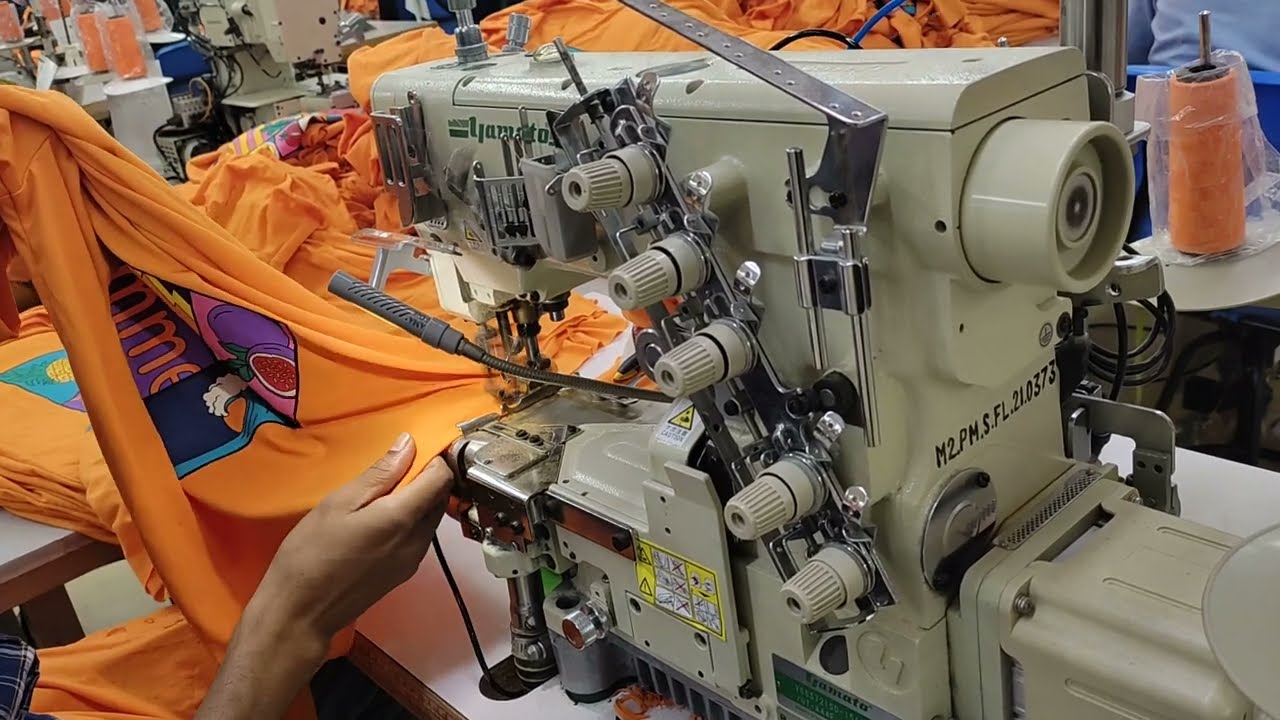 Flatlock sewing machine, bottom hem process of basic t-shirt. A grad very skill operator.