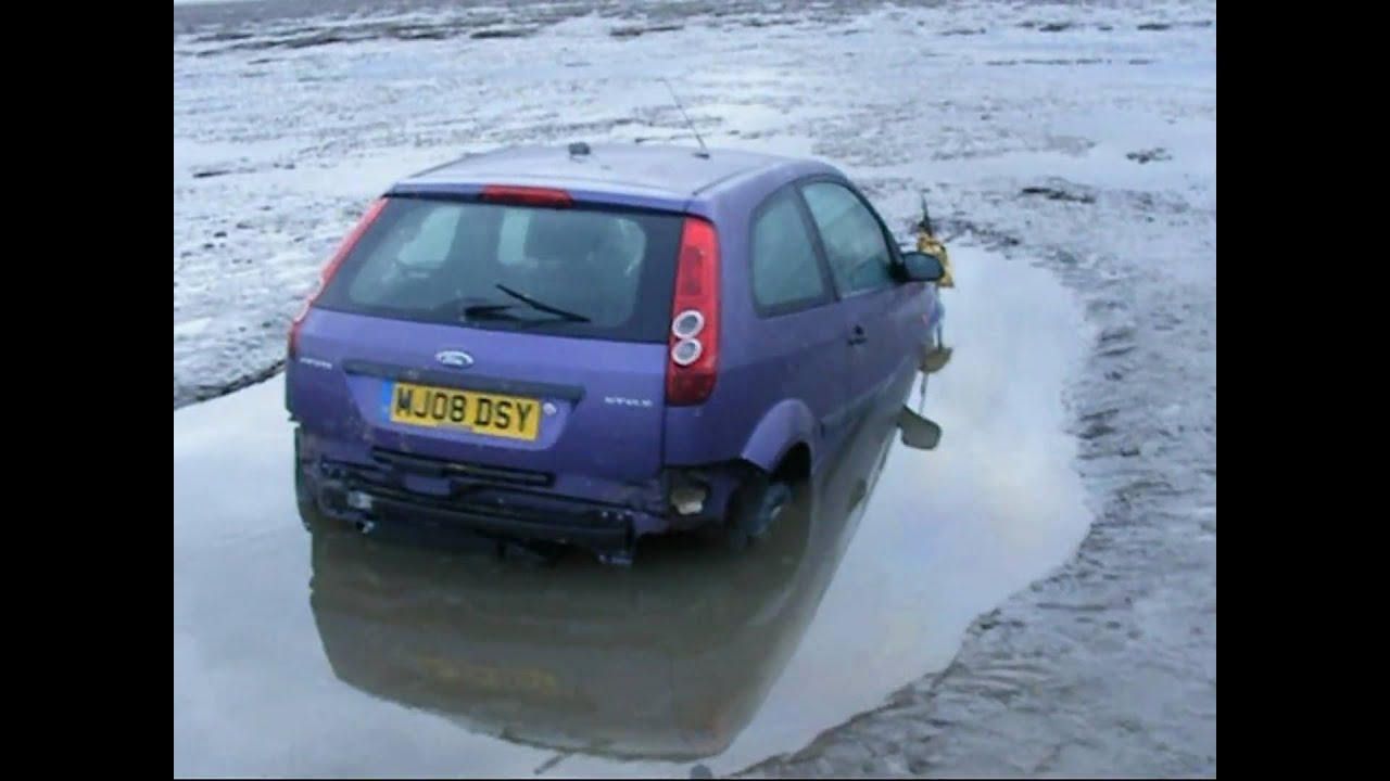 Stranded car retrieved from mud