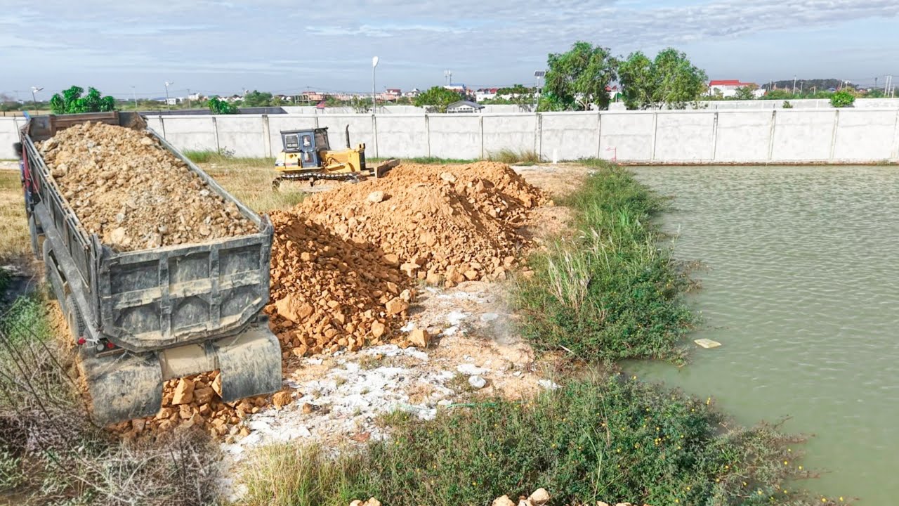 Amazing action!!! Delete huge pond utilities skill Komatsu d41 push soil rock and Heavy dump trucks