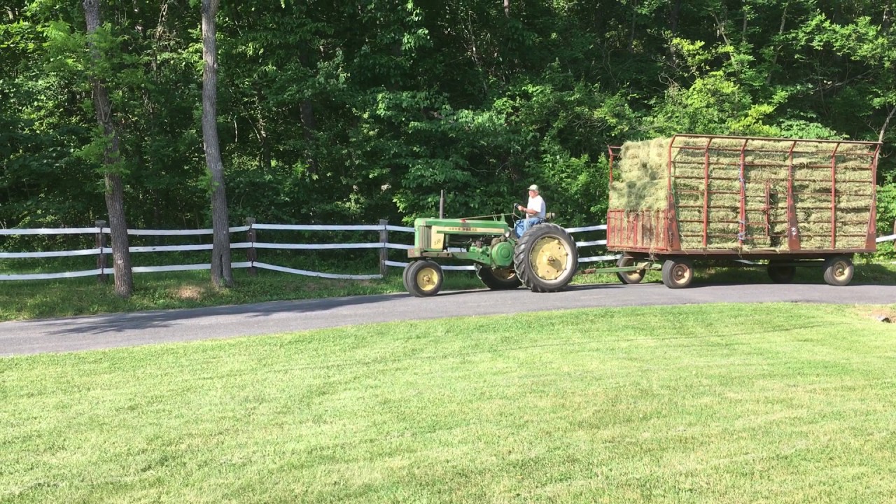 john deere 520 pulling hay wagon
