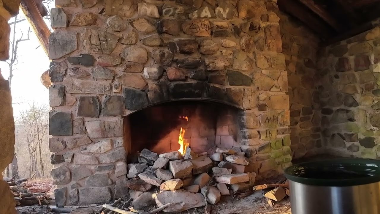 coffee by fireplace stone shelter woods