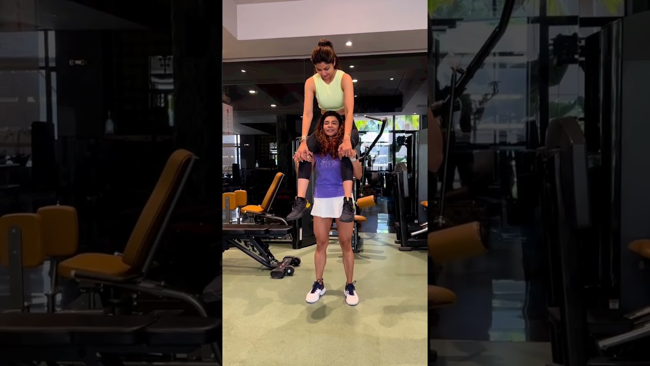 Shilpa Shetty's gym trainer litfting Shilpa on shoulder