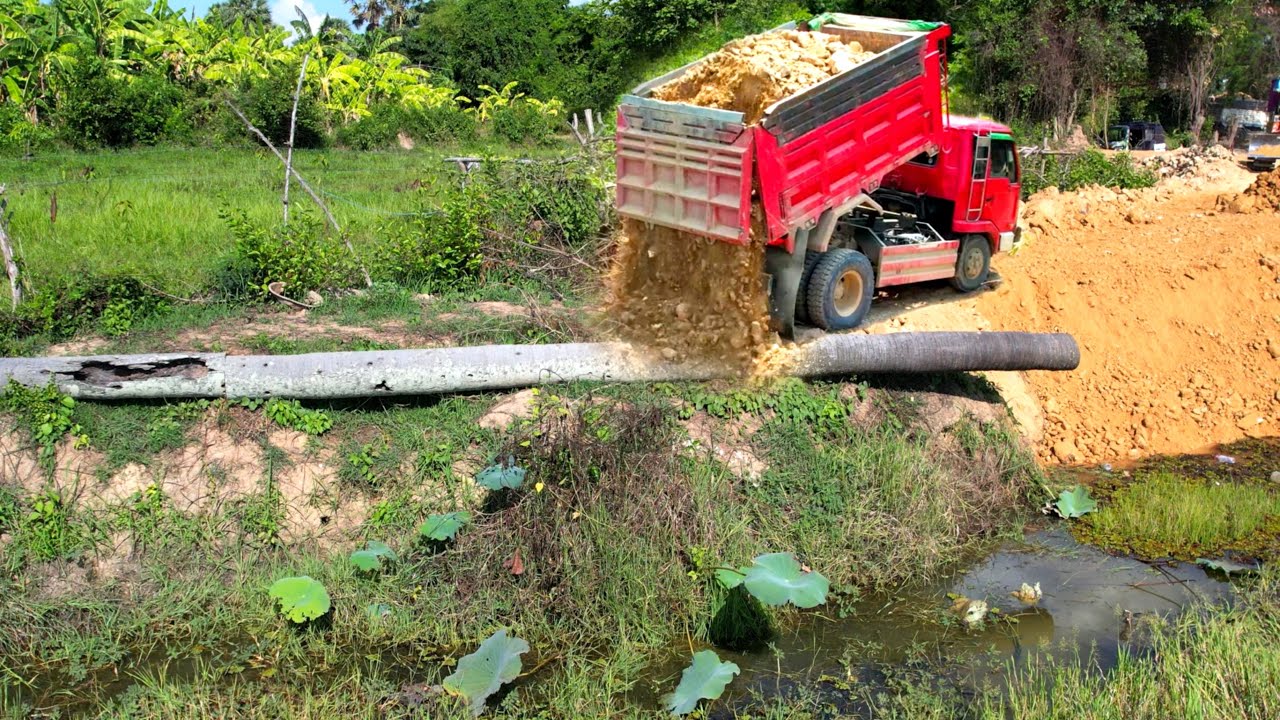 Incredible !! Dump truck 5T unloading soil landfilling repair road with operator bulldozer pushing.
