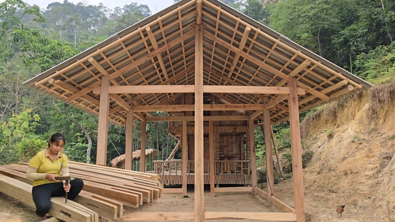 The girl built the wooden house from start to finish by herself.