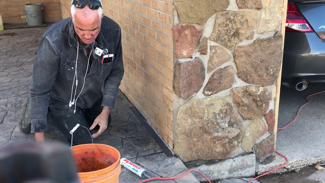 How to caulk concrete floor or driveway up against a wall.