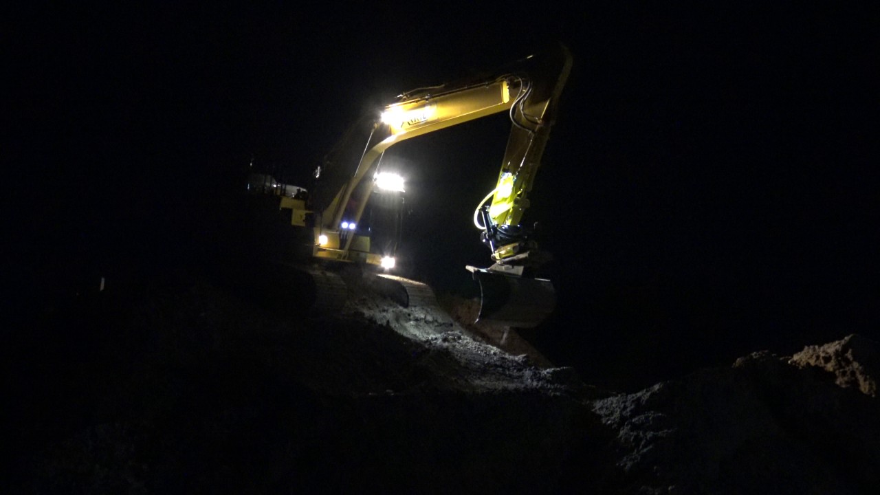 New Komatsu descending from a stockpile of dirt