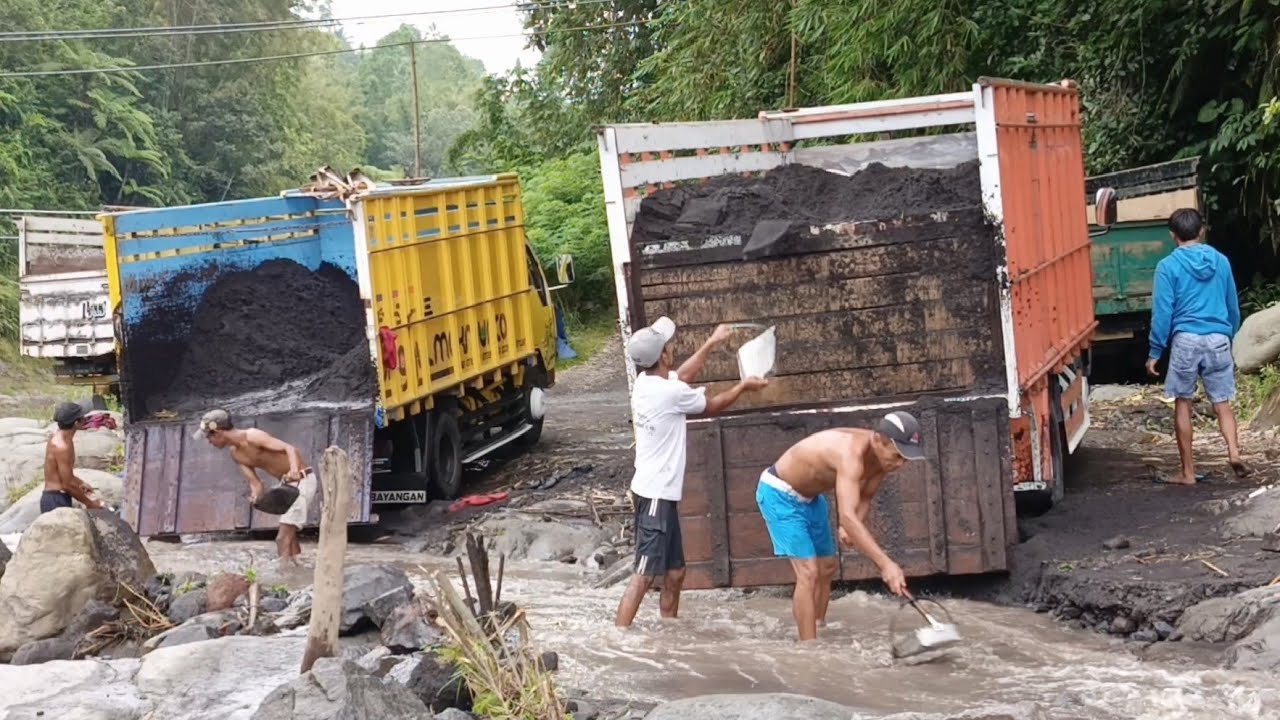 Manual Miners Load Sand Into the Truck Bed With Two Loading Lanes