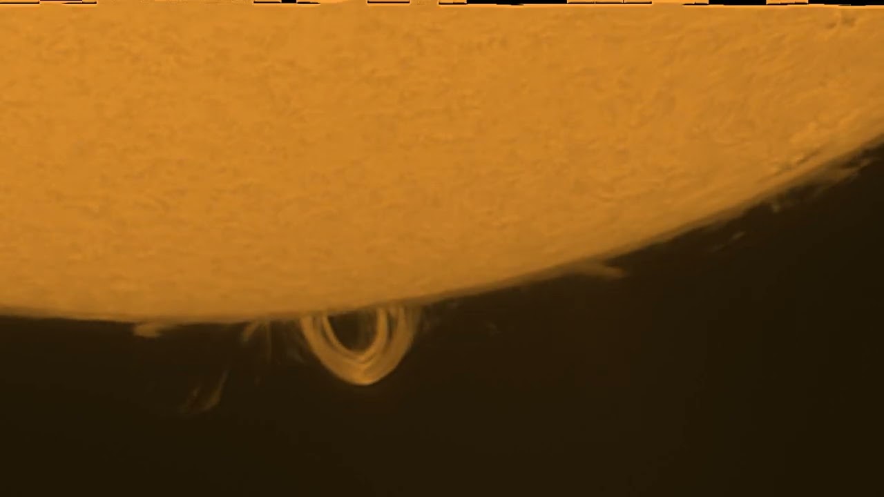 Time lapse of very bright loop-shaped solar prominence.