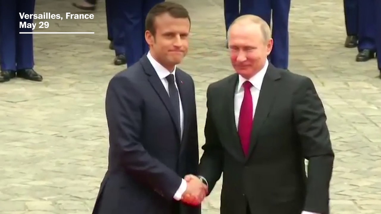 Putin and Macron shake hands in Versailles