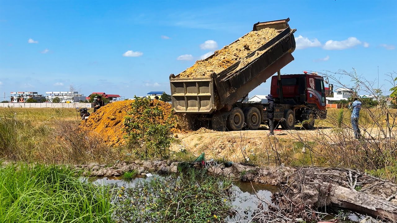 How wonderful bulldozer and dump trucks filling land amazingly and quickly skill