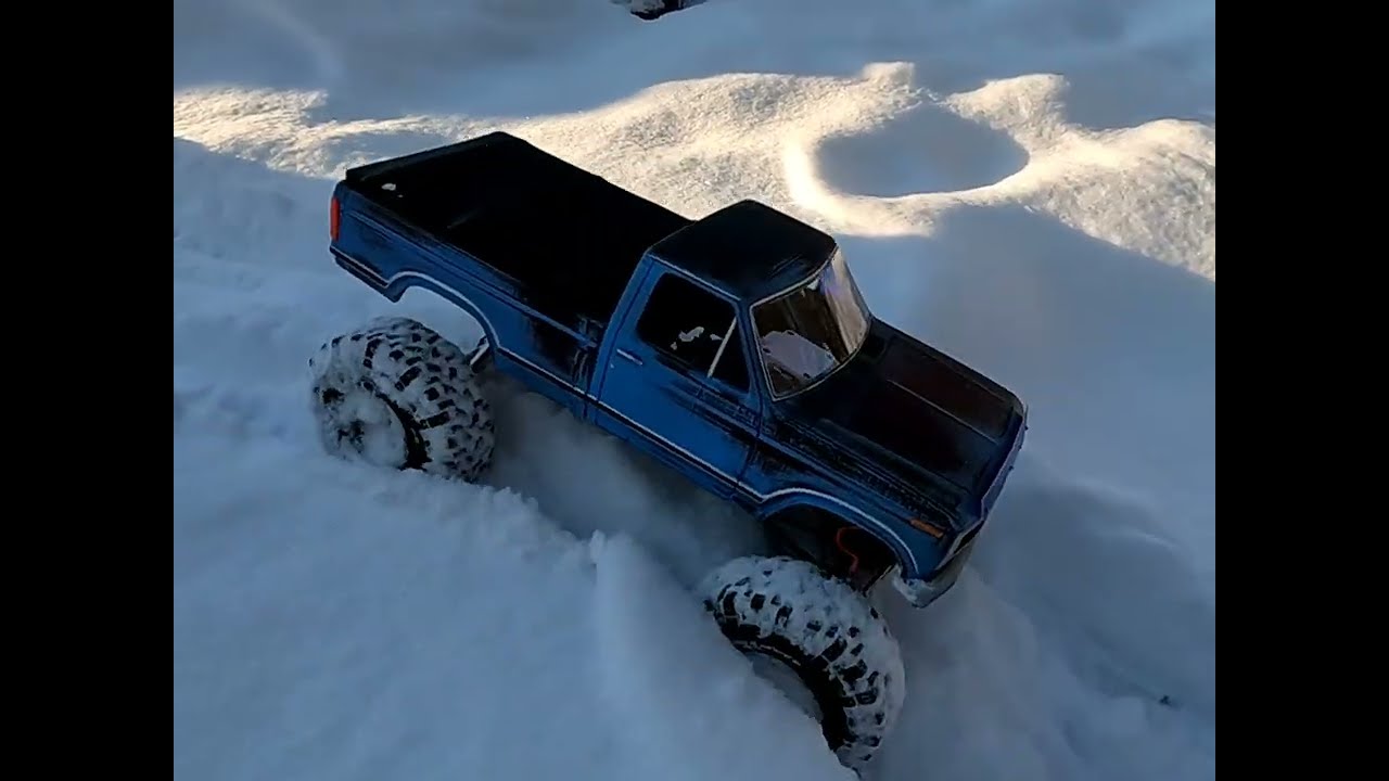 RC crawlers in the snow making new trails in the fresh snow 