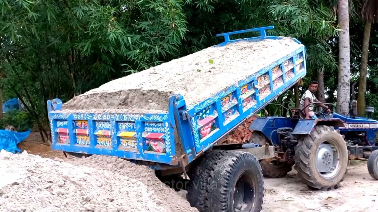 Sand is load from the river into tractors and unload over rough roads through hydraulic facilities.