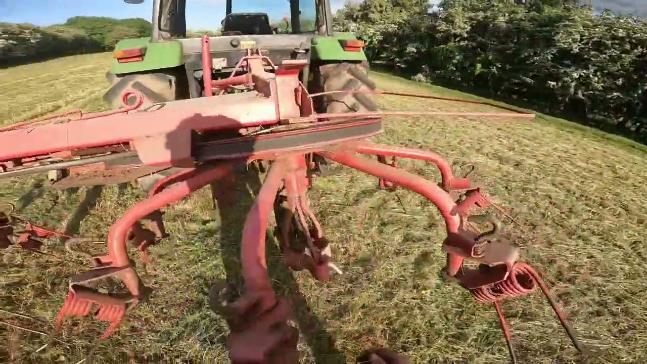Cab view I Turning hay in a John Deere 2450