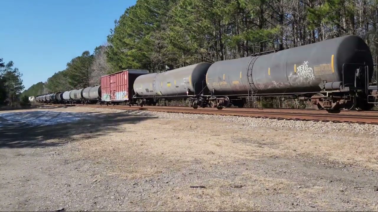 Amtrak train P090 and CSX train M410 passing on through as snow melt away