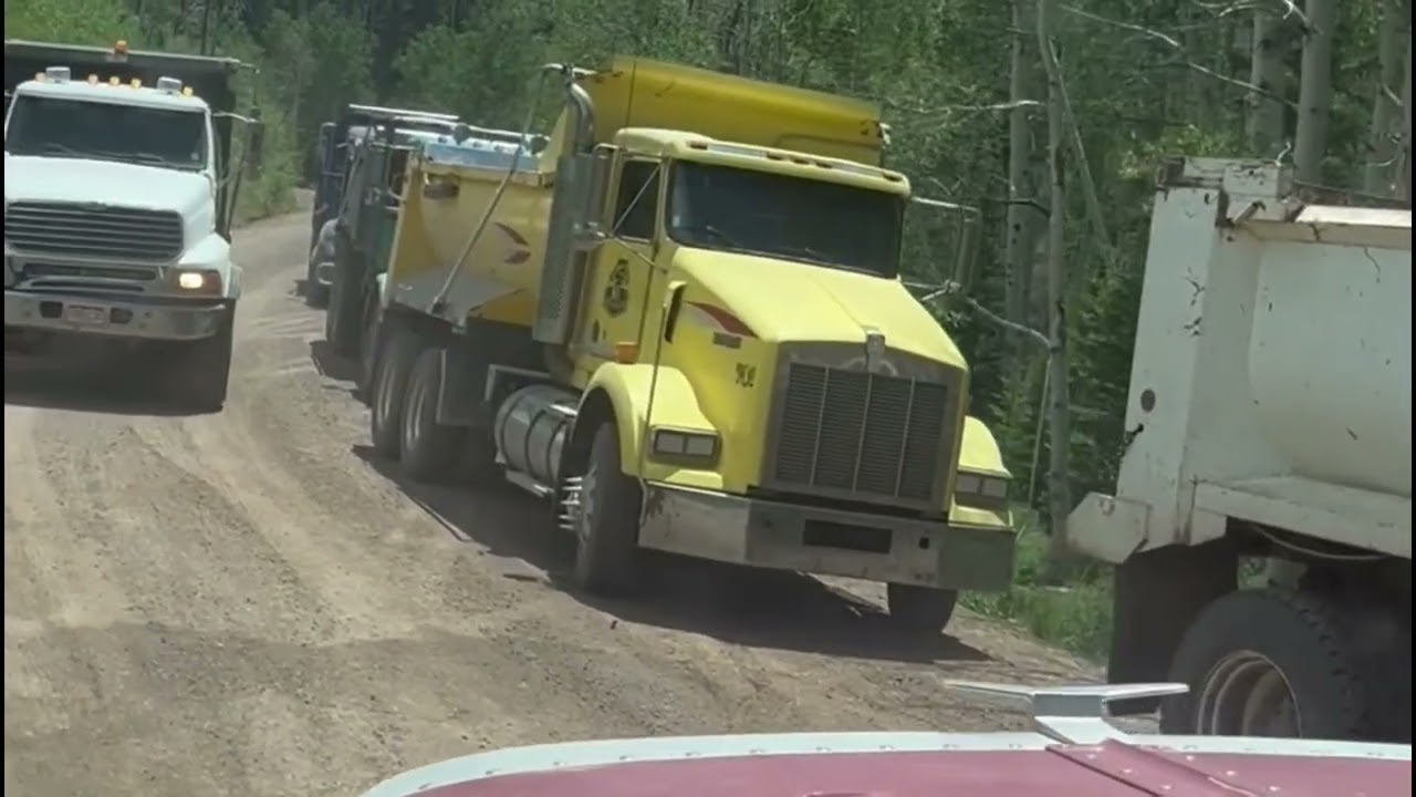 Trucks Hauling Gravel On A Dangerous Mountain Road
