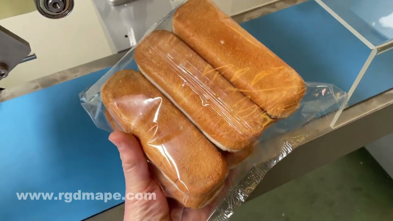 MÁQUINA EMPAQUETADORA FLOW PACK PARA ENVASADO DE PAN DE HAMBURGUESAS Y PERRITOS CALIENTES, RGDMAPE.
