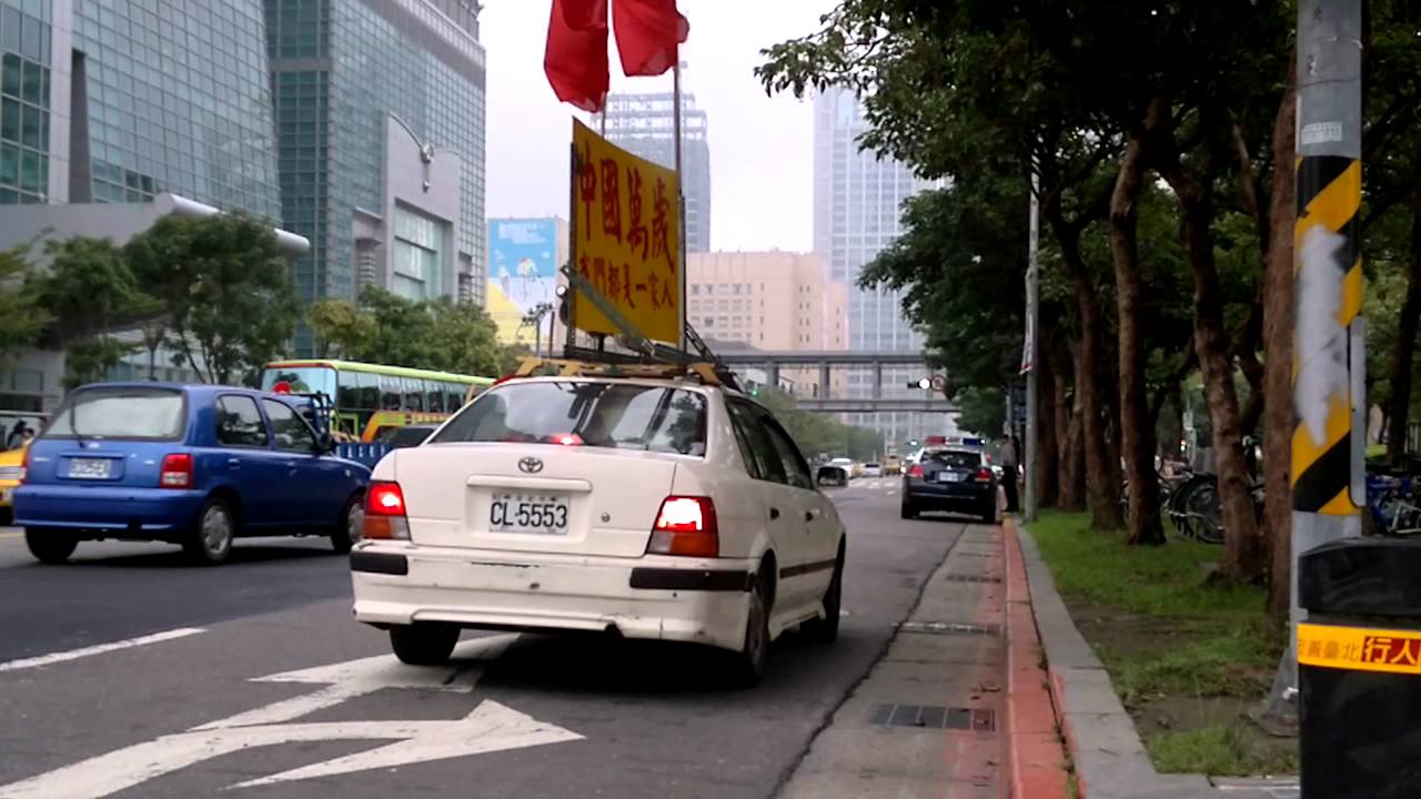 Chinese propaganda car of Xinyi patrolling around Taipei 101