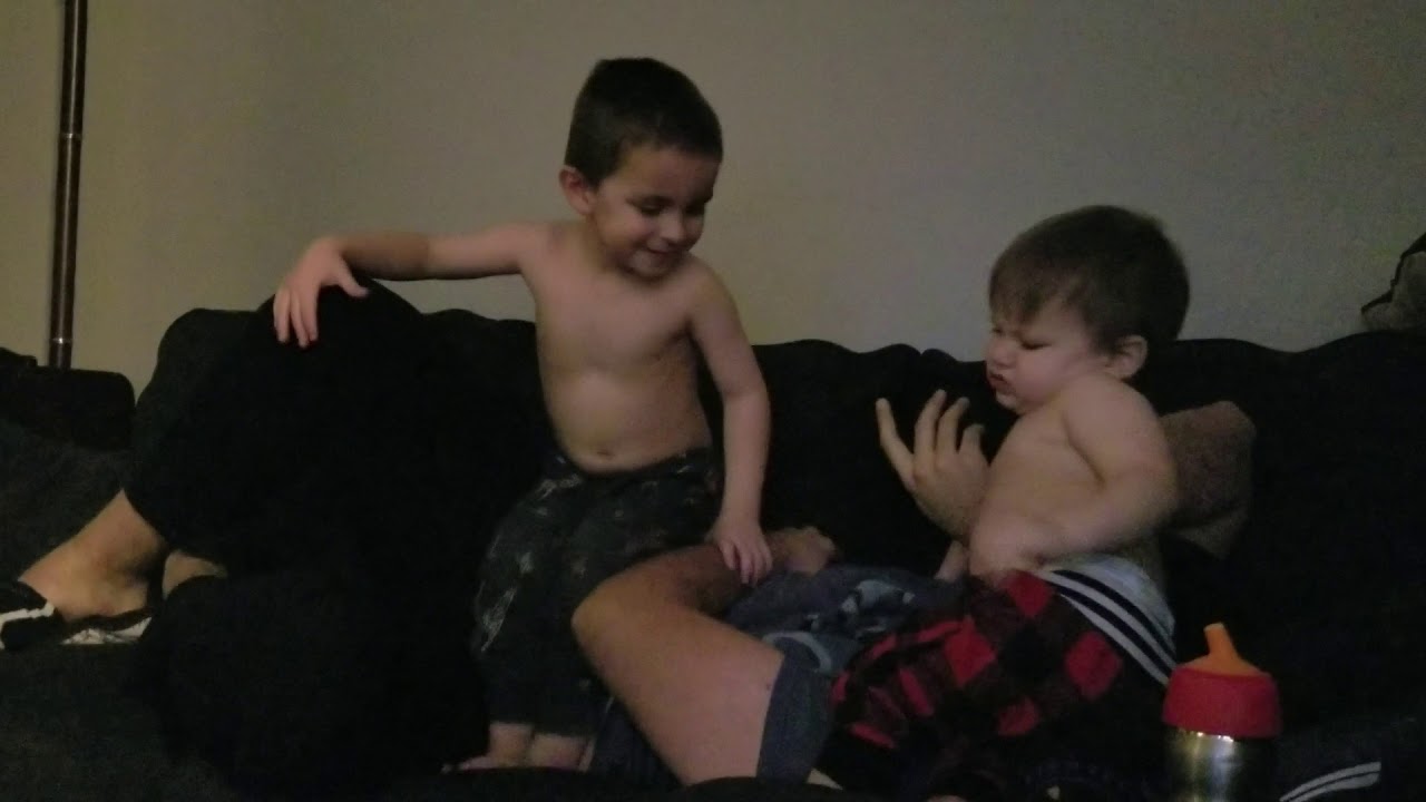 The boys jumping on dad