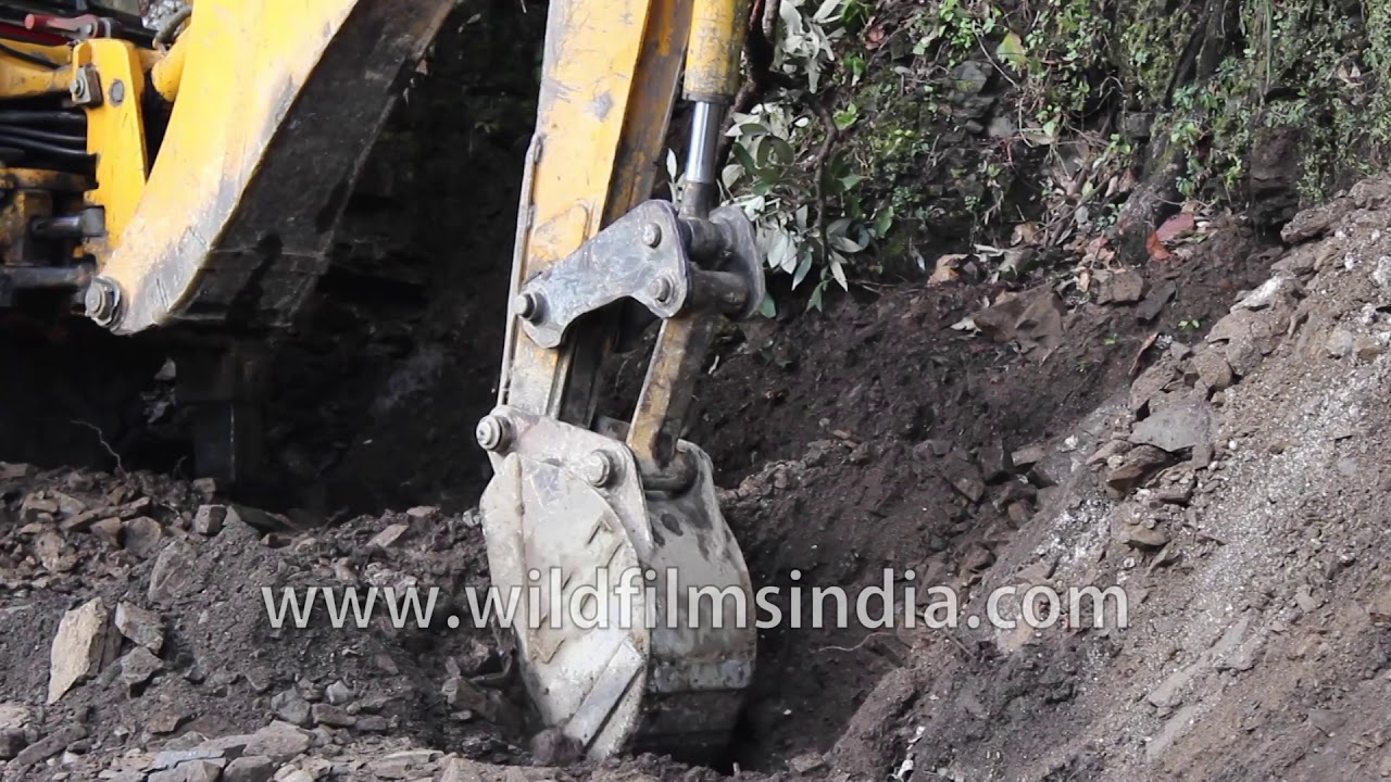 JCB clearing the road of debris after a landslide in India