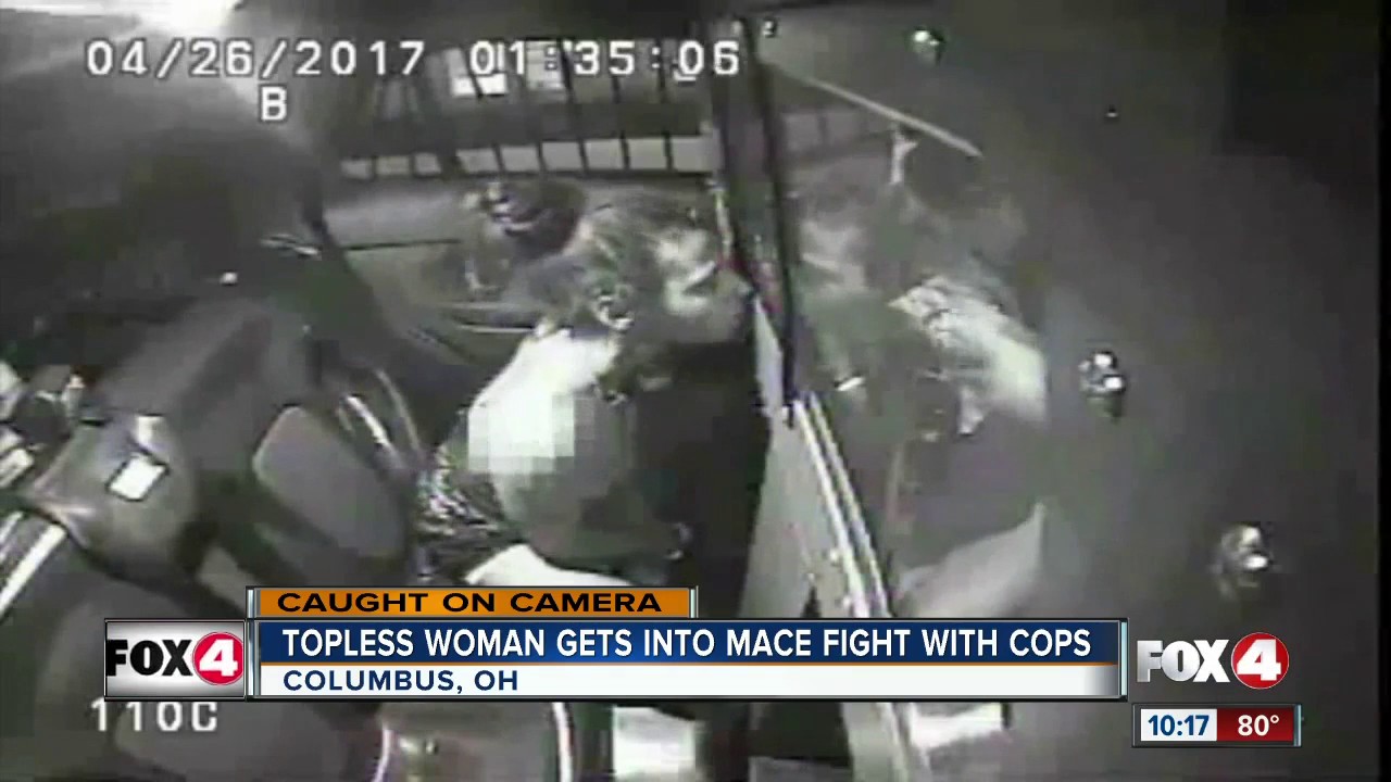 Topless woman tries to mace police officers