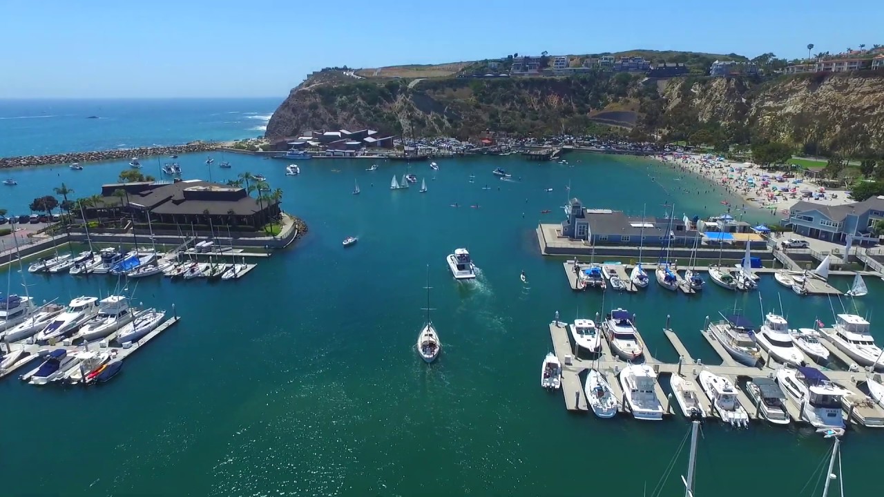 Drone Scenic Aerial View of Dana Point Marina, Beach, Harbor - Sailboats, Kayaks, SUP Paddlers