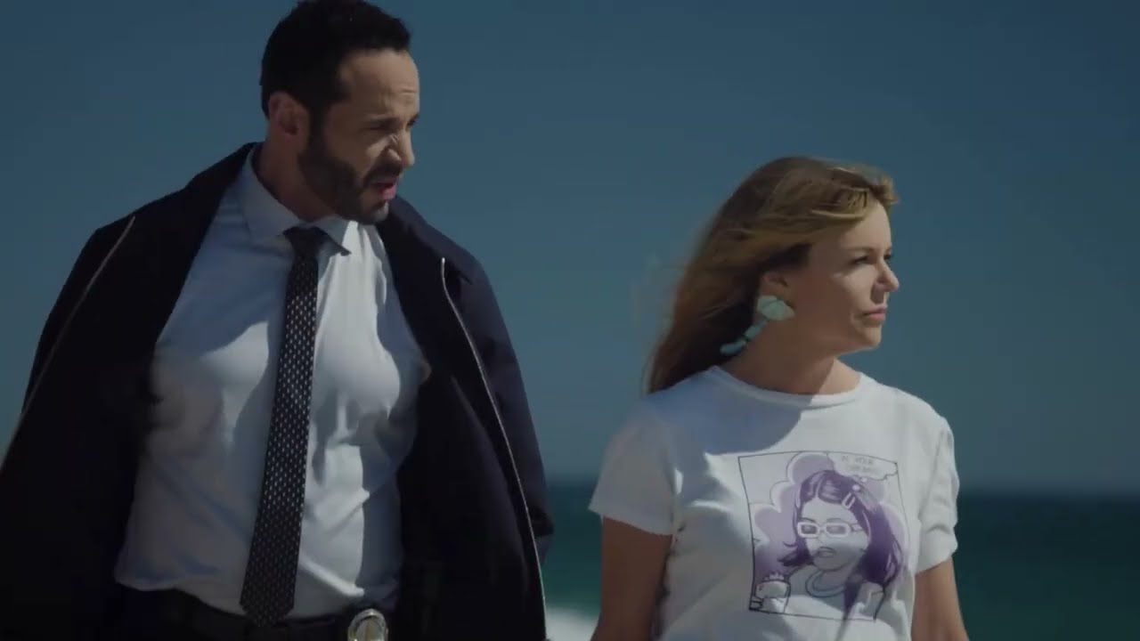Woman Police Consultant Removes Her Boots as she Walks on Beach (TV Scene) [Black Socks]