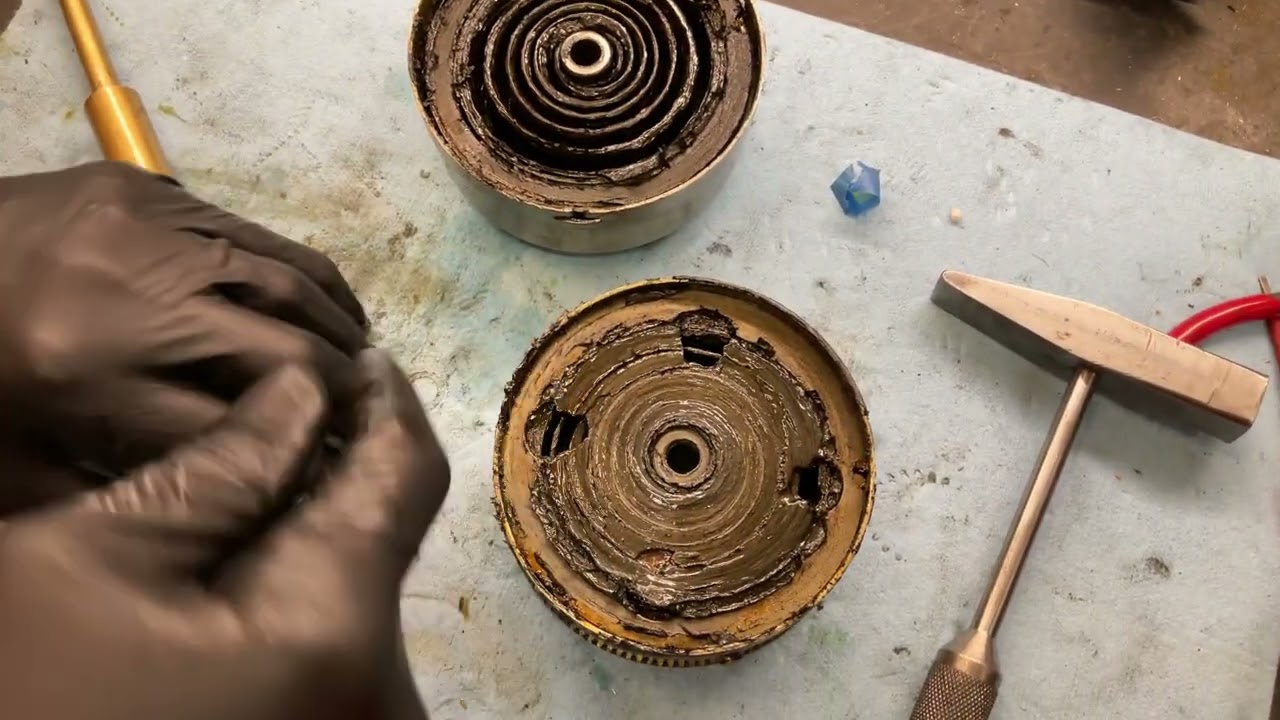 963.  Pulling apart the spring barrels on a Brunswick 4-spring motor