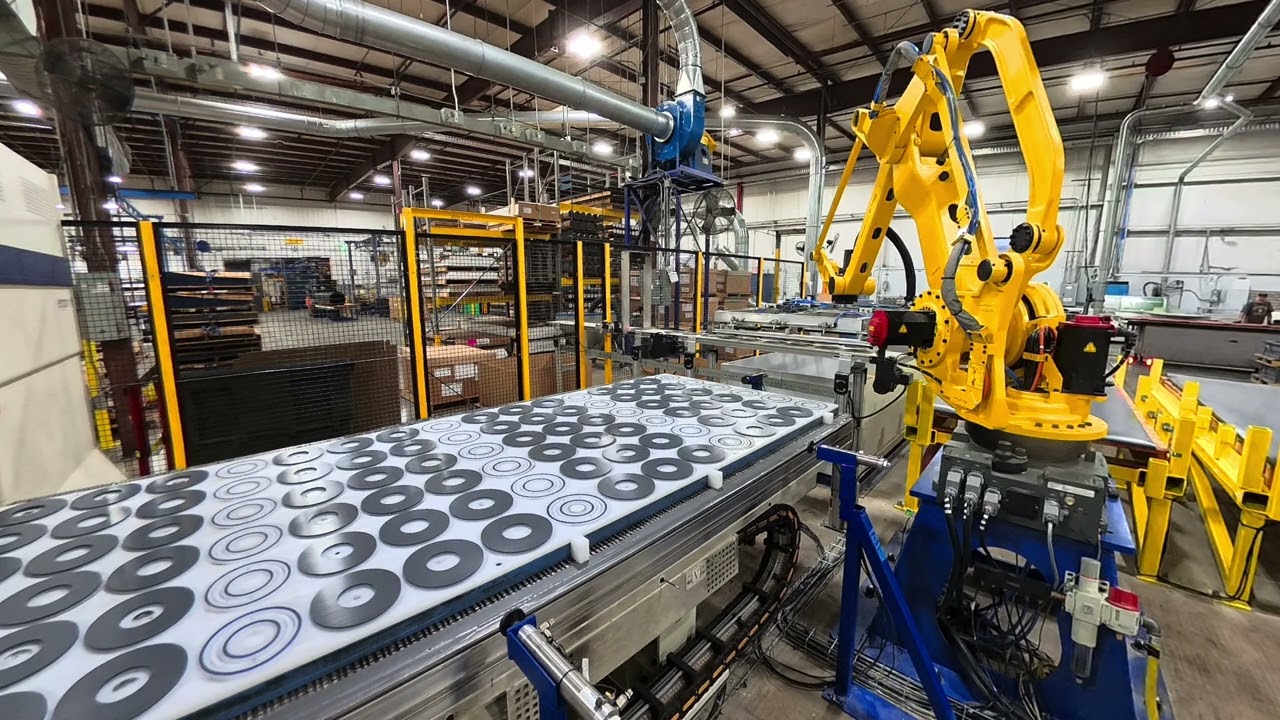 Robotic machine tending of a CNC router with a Fanuc robot 