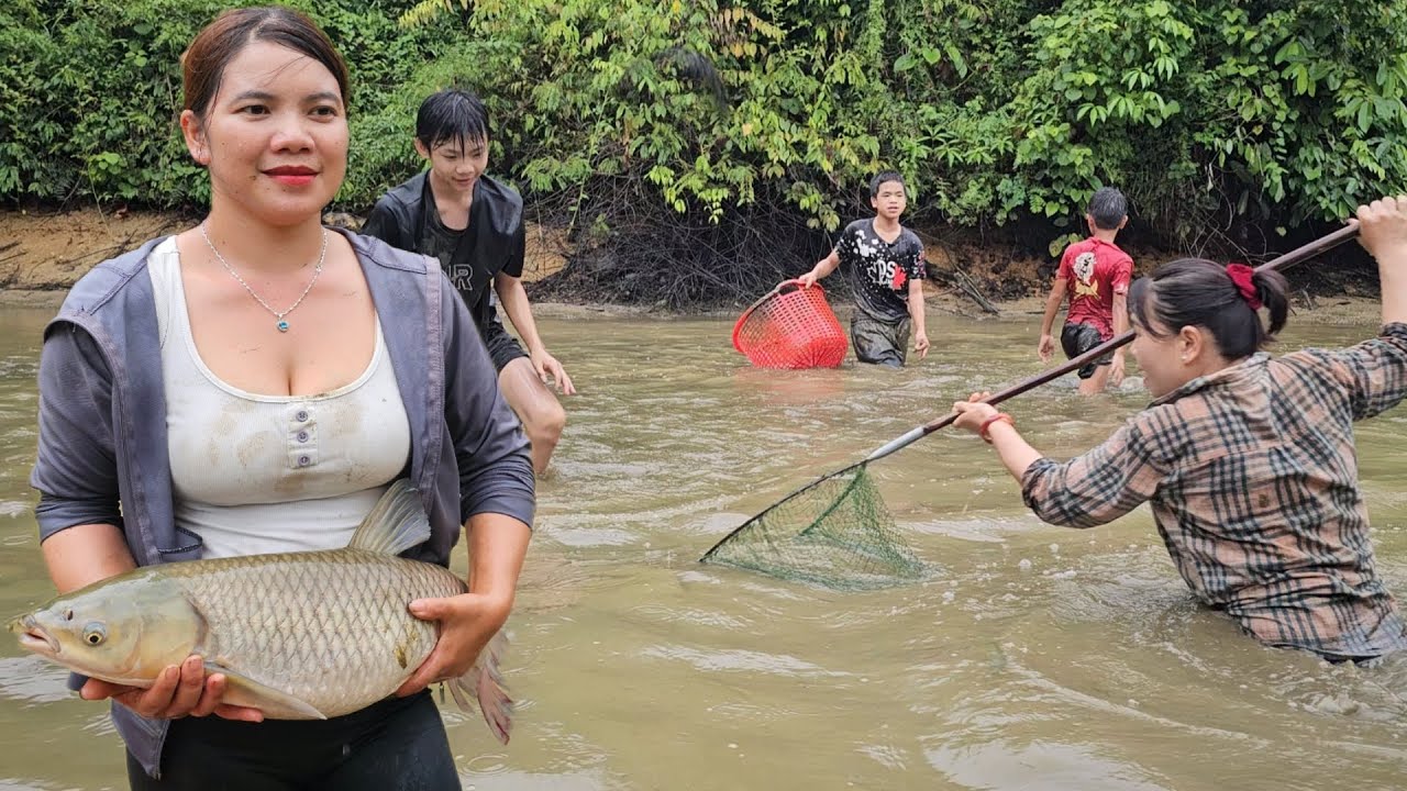 Country girl harvesting fish in pond.
