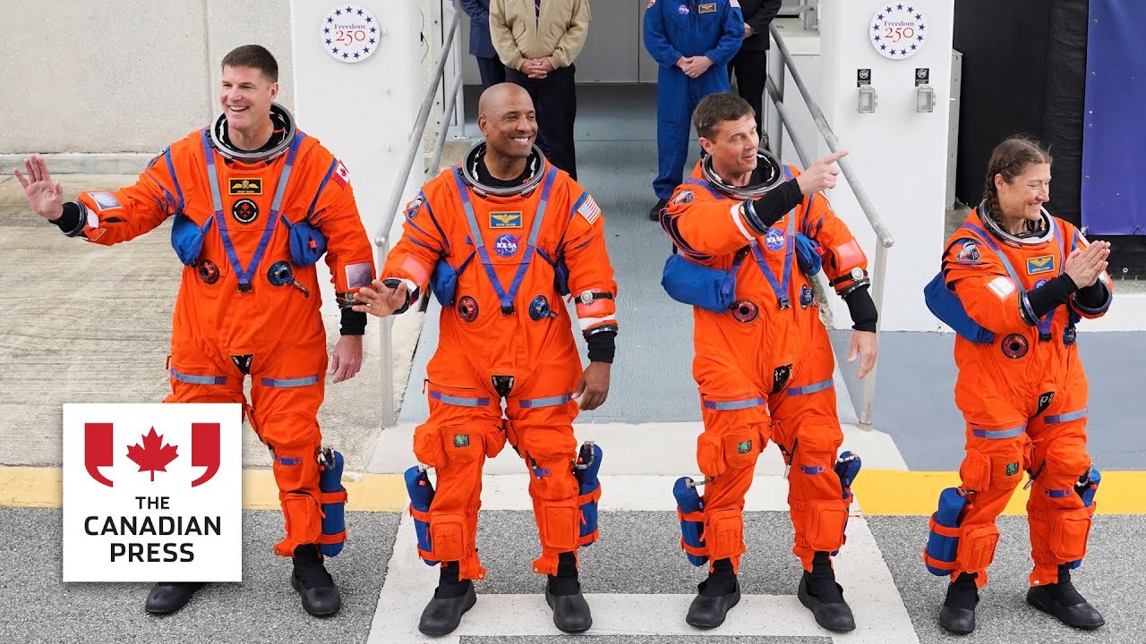 Canadian Jeremy Hansen leaves crew quarters with fellow astronauts ahead of moon launch