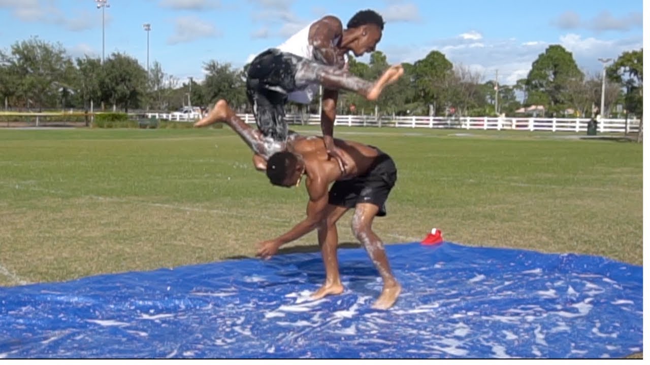 PLAYING TACKLE FOOTBALL ON A SLIP AND SLIDE