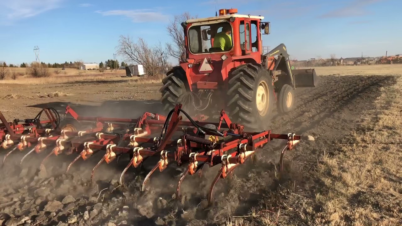 My Neighbors bad-a** Allis-Chalmers 200 1975 tractor pulling a cultivator on virgin ground.
