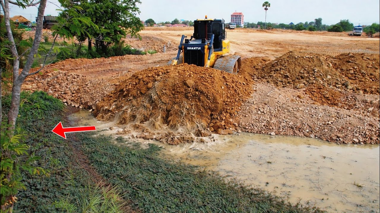 Powerful￼ SHANTUI Bulldozer Pushing Soil Fill Huge Pit With heavy dump truck pouring soils 