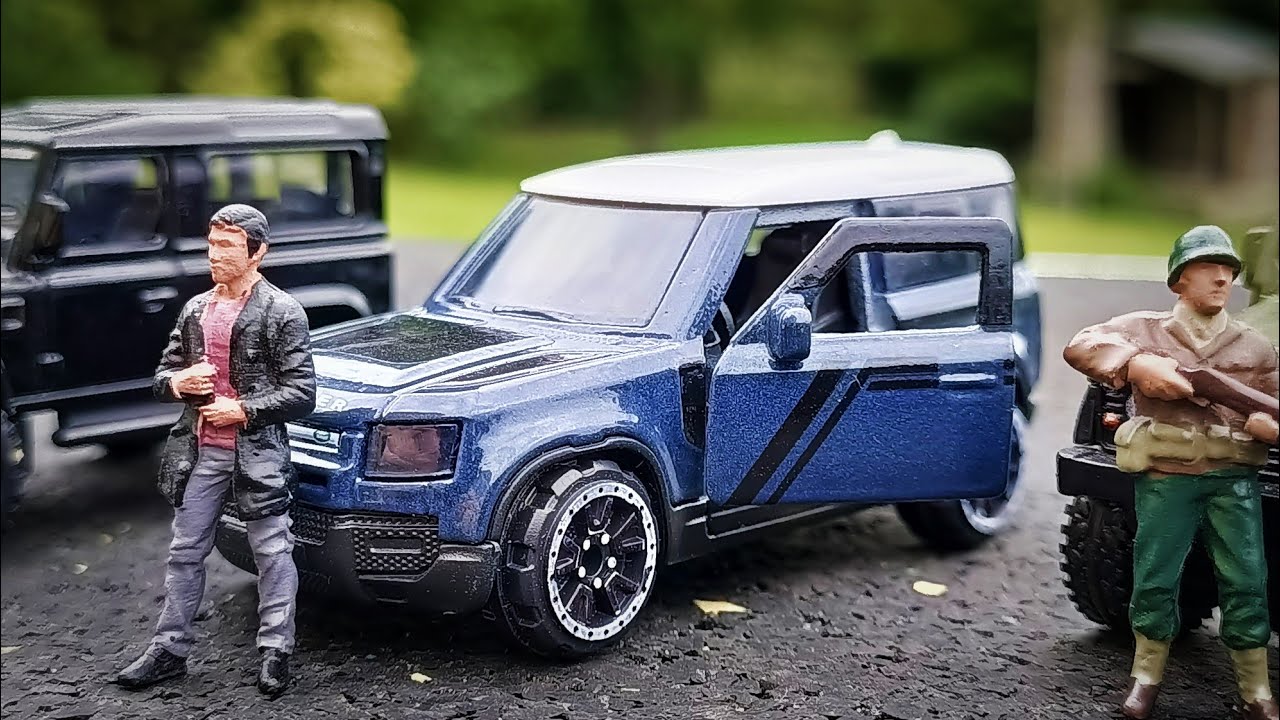 Majorette Land Rover Defender alongside some old Defenders
